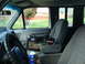 1989 Ford F-250 - The interior of a truck cab is shown, a toolbox and a bottle of brake fluid.