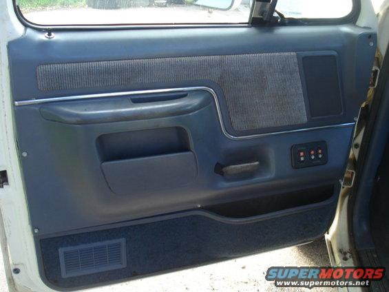 1989 Ford F-250 interior door panel with blue fabric and power window controls