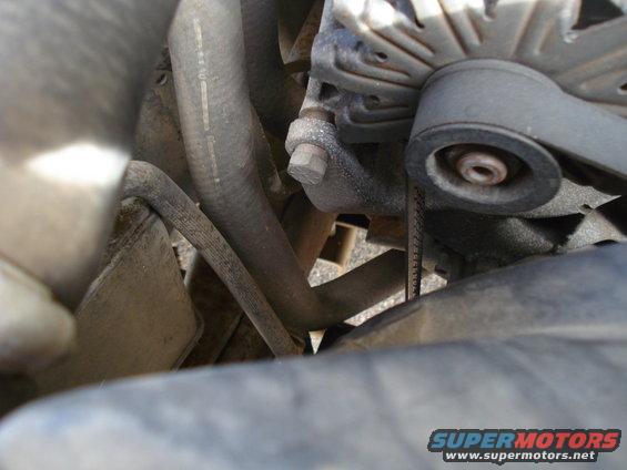 1989 Ford F-250 engine bay with alternator, hoses, and belt visible