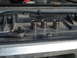 1989 Ford F-250 - A socket wrench and three sockets are laid out on a dark surface, suggesting a repair or maintenance task.