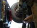 1989 Ford F-250 - Changing the oil on a vehicle, focusing on the oil pan and surrounding undercarriage components.