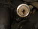 1989 Ford F-250 - Close-up view of an oil filter adapter, showing signs of oil leakage.