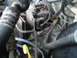 1989 Ford F-250 - A detailed view of various engine components, including hoses and electrical connectors, within the engine bay.