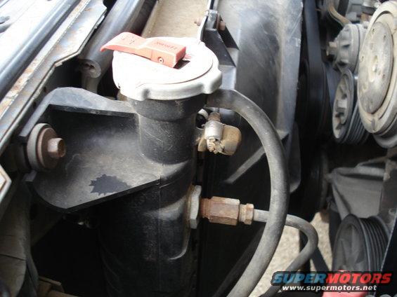 Engine coolant reservoir and fan assembly of a 1989 Ford F-250