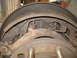 1989 Ford F-250 - Close-up view of a rusty drum brake assembly, showing brake shoes and springs.