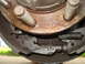 1989 Ford F-250 - Close-up view of a vehicle's brake drum and shoes, showing internal components and some rust.