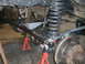 1995 Ford Bronco - The front suspension and steering components of a vehicle are visible, supported by red jack stands.