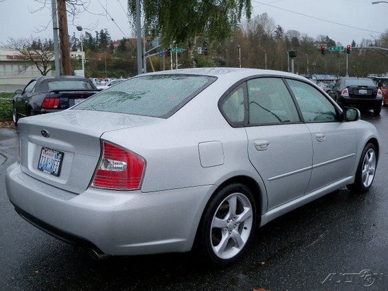 Silver 2006 Subaru Legacy sedan, rear 3/4 view. License plate is visible
