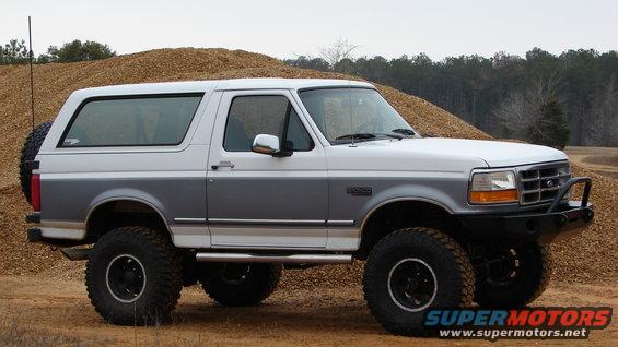 1995 Ford Bronco with aftermarket front bumper and lifted suspension