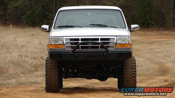 White 1995 Ford Bronco front view with aftermarket bumper and large tires