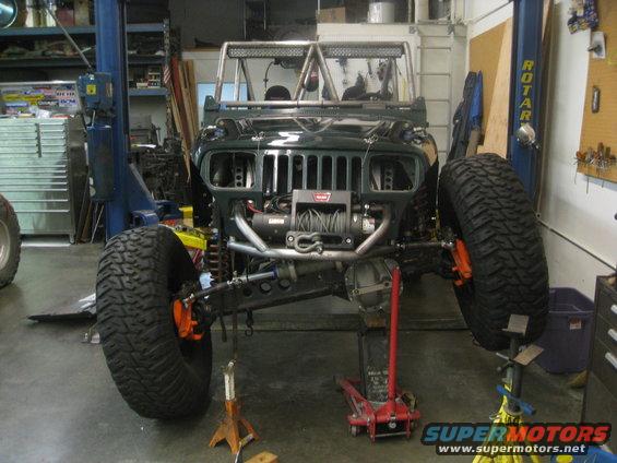 Dark green Jeep YJ front view with winch and large tires