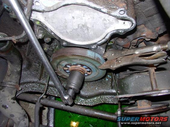Taking the crank bolt out of the balancer with the visegrips holding against the two foot bar.