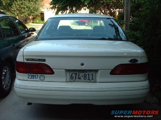 Rear view of a 1996 Ford Taurus sedan parked next to another car