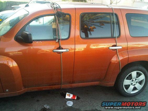 Orange SUV side view with rope attached to roof rack
