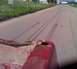 1988 Ford F-250 - View from the bed of a red truck shows tire tracks on an asphalt road.