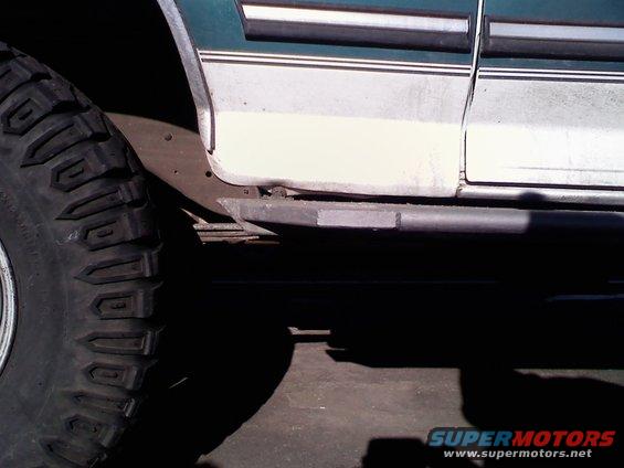 1996 Ford Bronco side view showing a large off-road tire and a black slider bar