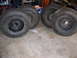 2001 Dodge 1500 - Four large off-road tires and wheels are shown, likely for a truck or SUV.