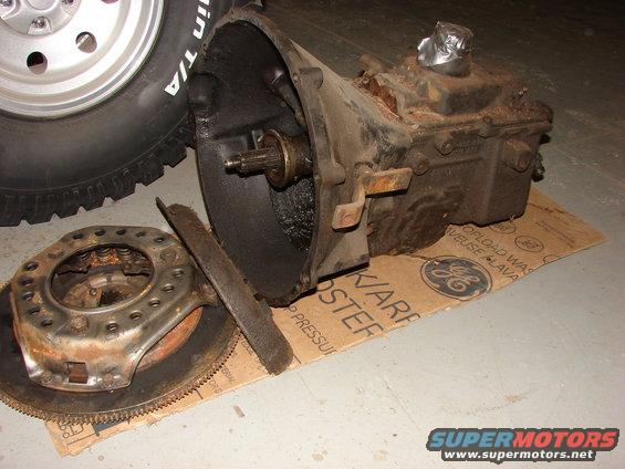 Transmission and clutch assembly on cardboard with tire in background