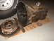 1971 International School Bus - Transmission and clutch assembly components are laid out on a piece of cardboard, with a tire visible in the upper left corner.