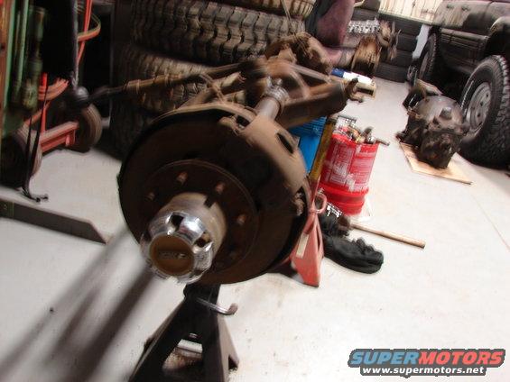 Front axle assembly on engine stand, chrome hubcap visible
