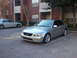 2008 Subaru Legacy - A silver sedan is parked in a lot in front of a brick building. Another car is parked behind it.