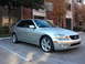 2008 Subaru Legacy - Silver Lexus IS sedan parked in a lot with a brick building and trees in the background.