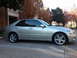 2008 Subaru Legacy - A silver sedan is parked in a lot with a brick building and trees in the background.