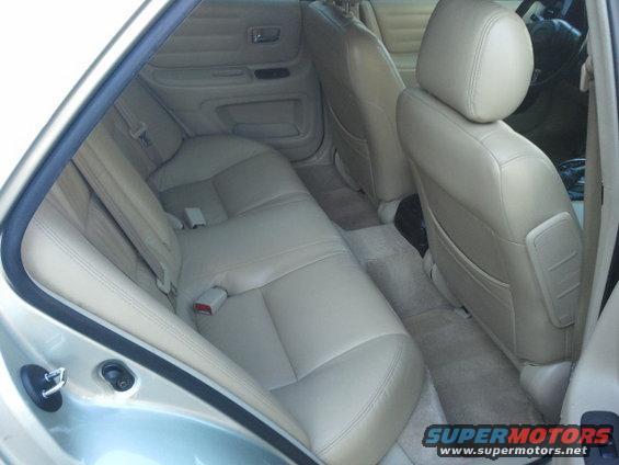 Interior rear seats and door panel of a light-colored car
