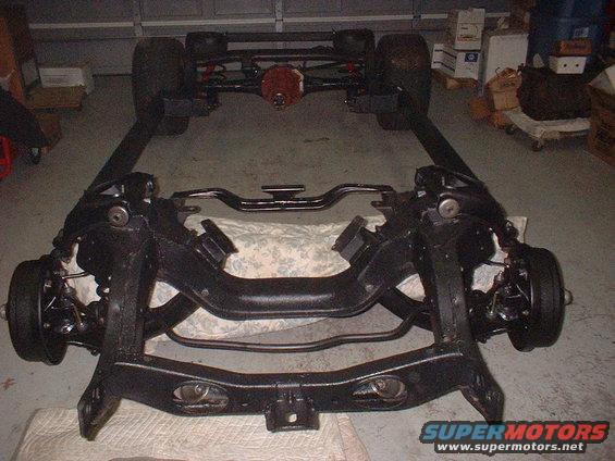 Car frame with front and rear suspension assemblies, wheels attached