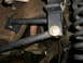1995 Ford Bronco - Aftermarket suspension components are installed on the vehicle's frame, with a visible coil spring and sway bar link.
