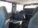 1993 Ford C-150 (Centurion Conversions) - The interior of the van shows multiple rows of seats and a cluttered floor.