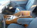 1993 Ford C-150 (Centurion Conversions) - The interior of a van shows cloth seats and a custom wooden center console with cup holders.