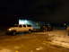 1993 Ford C-150 (Centurion Conversions) - A white Ford F-250 Super Duty tows a trailer carrying a dark SUV at night.