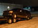 1993 Ford C-150 (Centurion Conversions) - Dark red SUV being transported on a trailer at night, likely a 1992 model.