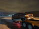 1993 Ford C-150 (Centurion Conversions) - Maroon Ford Bronco SUV being transported on a trailer under a cloudy night sky.