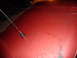1993 Ford C-150 (Centurion Conversions) - Close-up of a red car hood showing wear and a radio antenna.