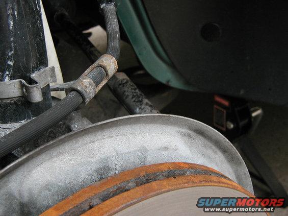 Looking down through the wheel well at where the rear bushing was removed.