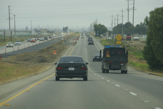 Black 1995 Ford Taurus rear view on highway