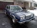 1983 Chrysler Fifth Avenue - Dark blue 1983 Chrysler Fifth Avenue sedan parked in front of a garage on a snowy day.