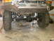 1995 Ford Bronco - Front view of a modified Ford Bronco's suspension and axle assembly, showing heavy-duty components.