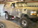 1995 Ford Bronco - This 1995 Ford Bronco, painted in camouflage, is shown on jacks with its suspension lifted.