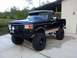 1990 Ford Bronco - This lifted Ford Bronco has a custom bumper and auxiliary lights.