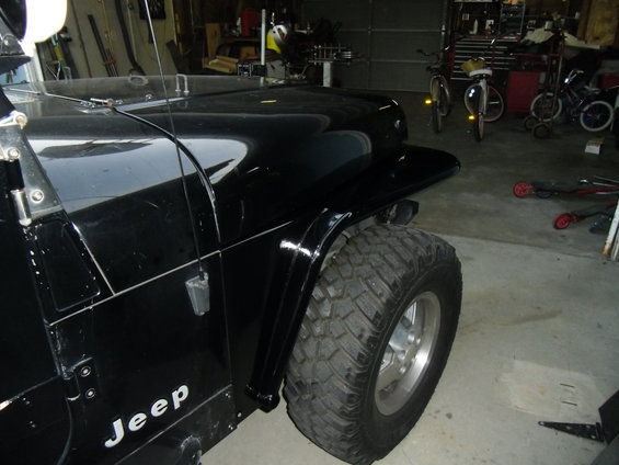 Black 1992 Jeep Wrangler fender and large off-road tire
