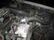 2000 Mercury Grand Marquis - Close-up view of engine components including the alternator and various hoses.