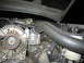 2000 Mercury Grand Marquis - Close-up view of an engine bay, showing the alternator and a prominent rubber hose.