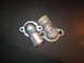 2000 Mercury Grand Marquis - Two automotive thermostat housings are shown against a dark background.
