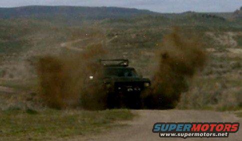 1979 Ford Bronco driving off-road, kicking up dust