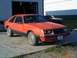 1983 Mercury Capri - This 1983 Mercury Capri is parked in front of a garage with another vehicle in the background.