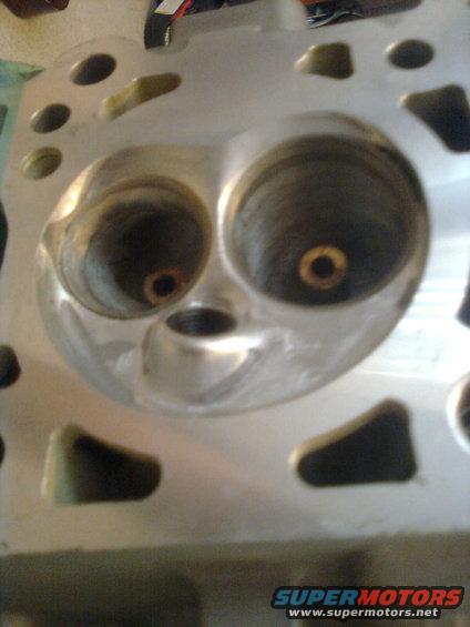 Engine cylinder head with two large intake ports and smaller exhaust ports