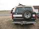 1992 Ford Bronco - Rear view of a 1992 Ford Bronco, showing its spare tire and two-tone paint scheme.